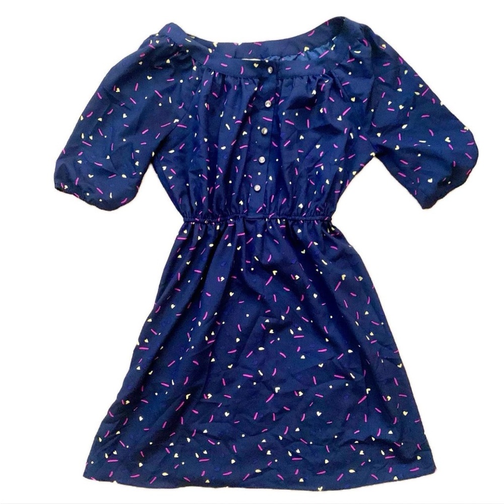 Adorable navy dress with retro confetti print and gem buttons. Ruched sleeves.